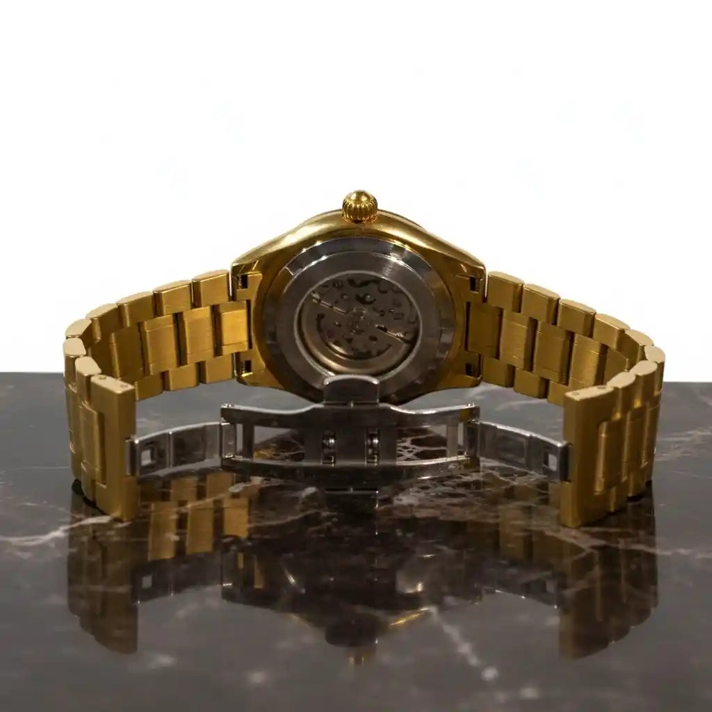 Retro dell'orologio MVL Double skull oro con cassa aperta e chiusura deployante su marmo
